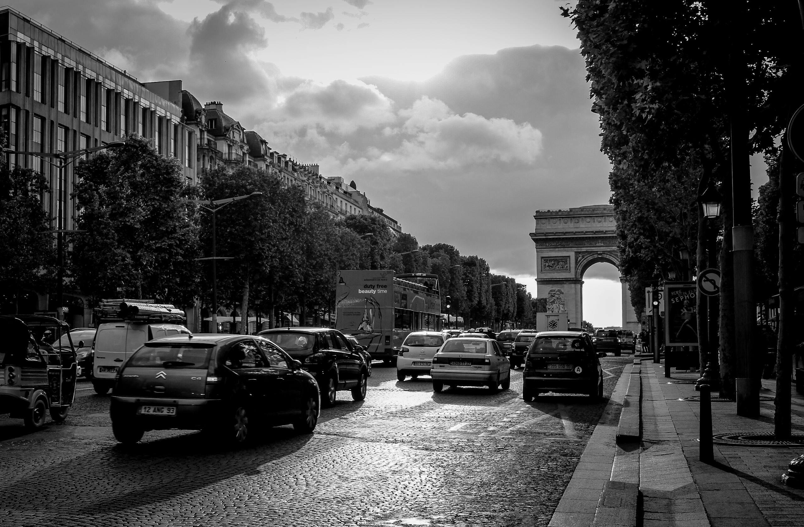 Grayscale Photo of Busy Streets With Building